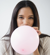 woman blowing up balloon